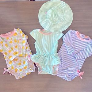 3 swimsuits size 12-18 mths and one hat.  All Ruffle Butts brand.
